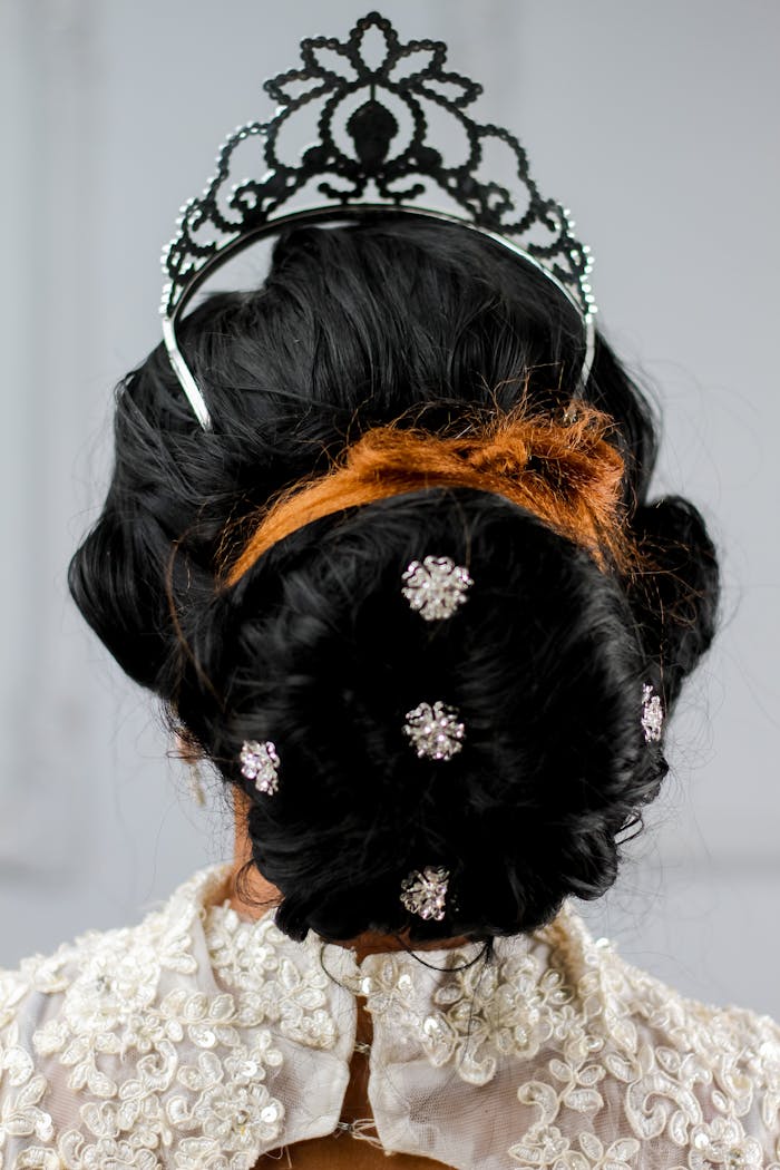 Bridal hairstyle featuring a tiara and decorative hair ornaments for a luxurious look.